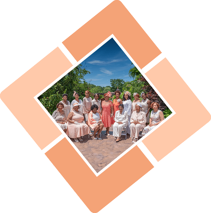 Group of women in hats and dresses.