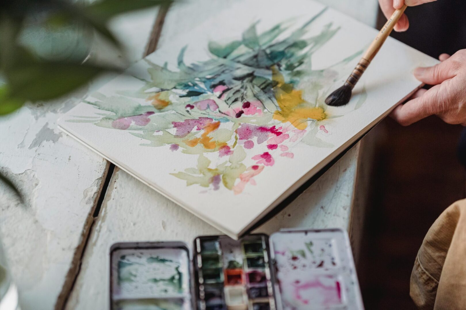 Watercolor painting of flowers being created.