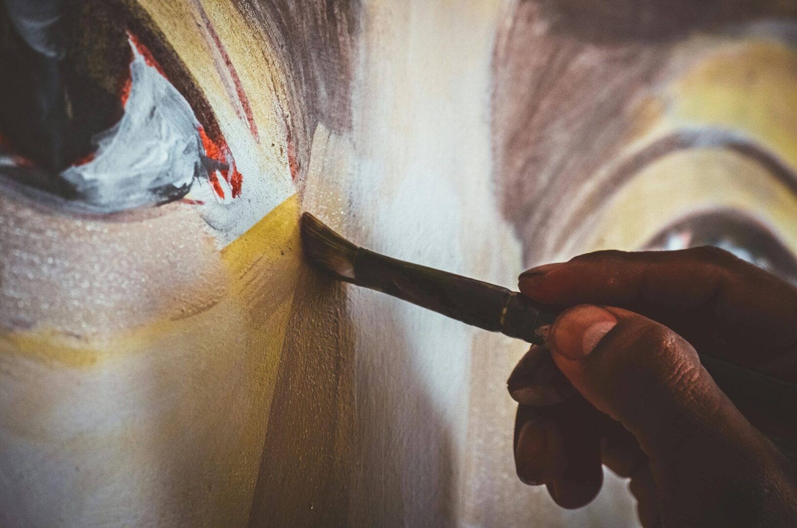 Hand painting an eye with a brush.