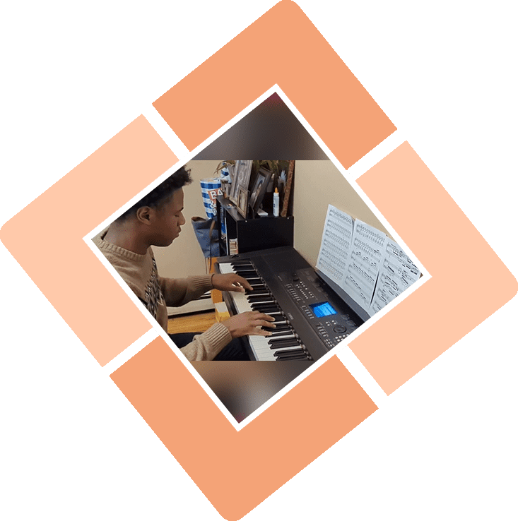 A young man playing a keyboard.